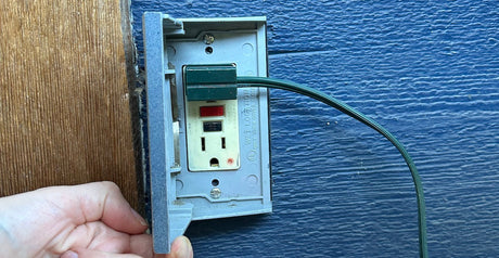 Christmas light plug plugged into power outlet